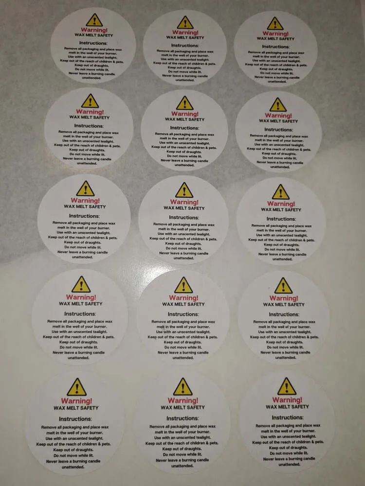 Small round wax melt safety labels arranged on a sticker sheet